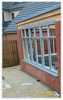 A conservatory being sprayed on-site